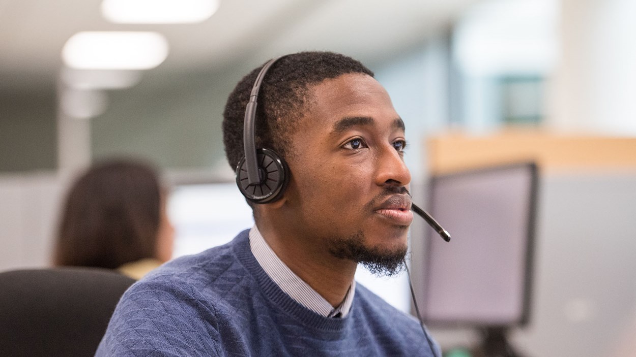 A man working at a computer, in a Skanska office