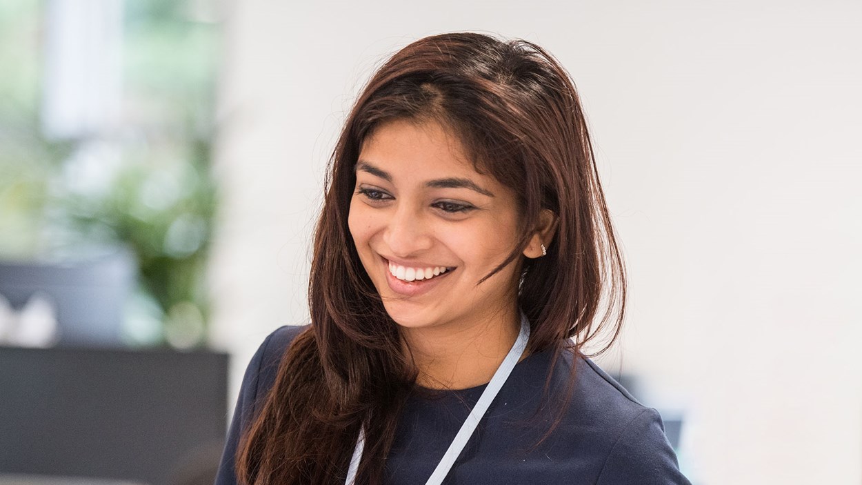 A smiling woman, at work in an office